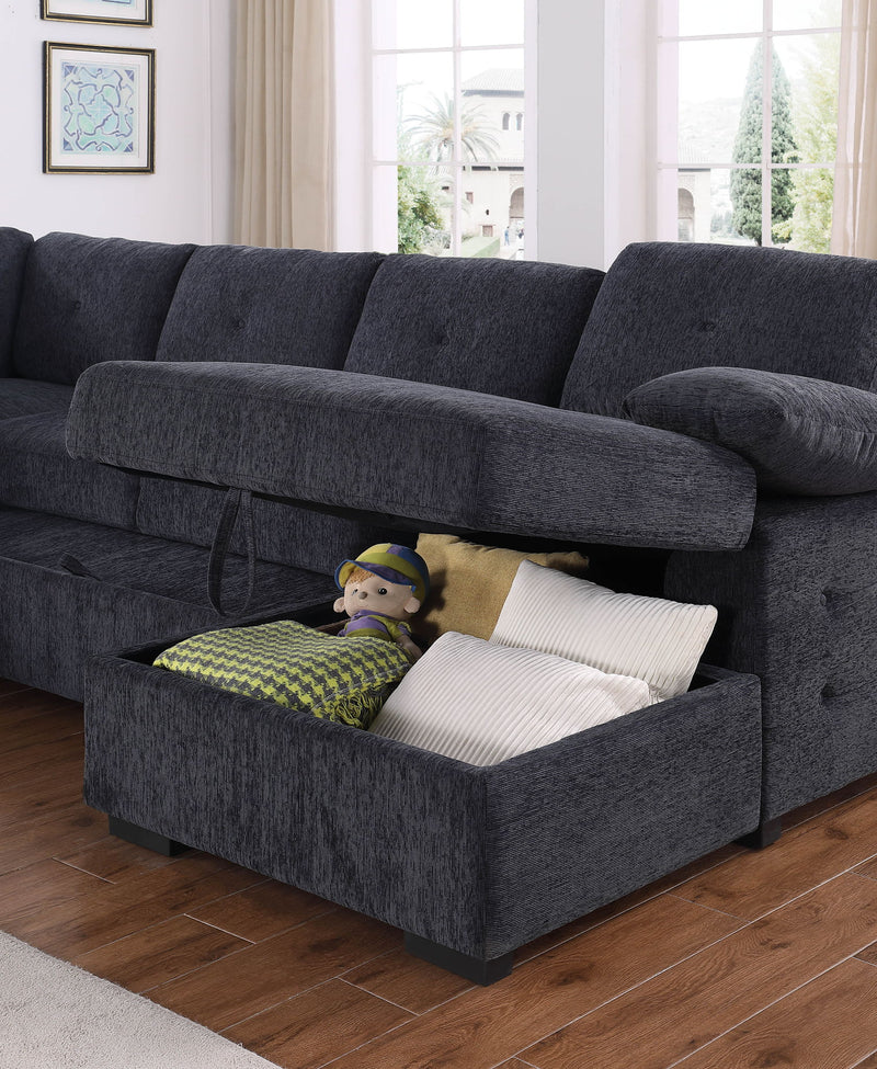 Dark gray sectional with open storage ottoman holding pillows and toys