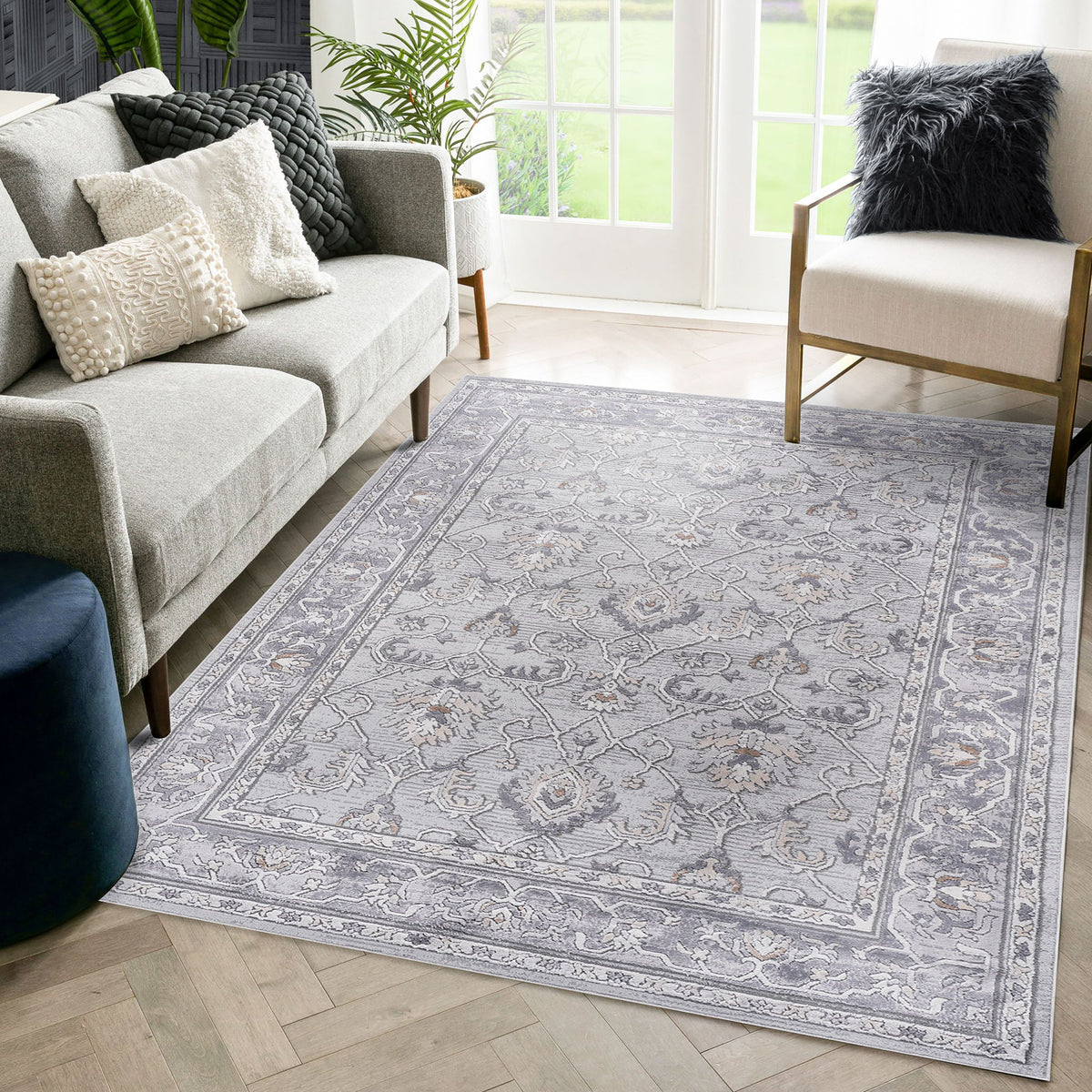 Gray and blue oriental area rug with floral medallion pattern and framed edges.