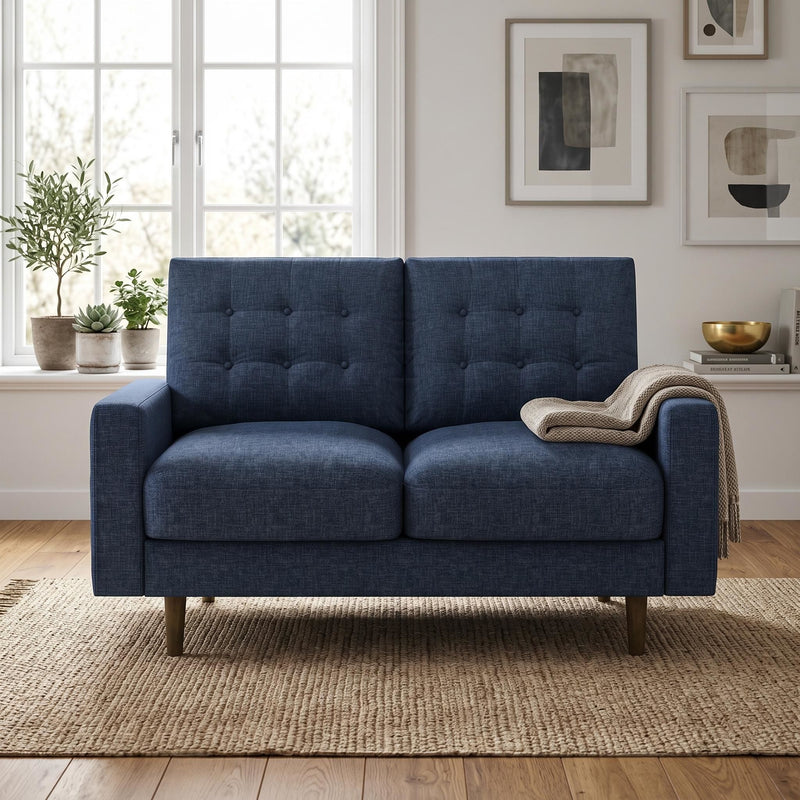Blue two-seat loveseat sofa with button-tufted back and tapered wooden legs