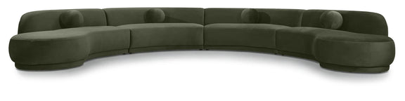 Green velvet sectional sofa with curved design and plush cushions