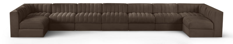 Dark brown velvet modular sectional sofa with tufted cushions and curved armrests