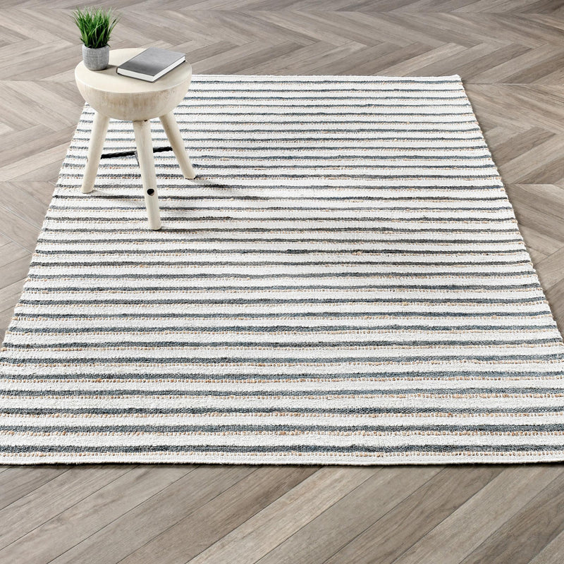 Ivory striped area rug with thin horizontal blue lines and distressed speckle detail