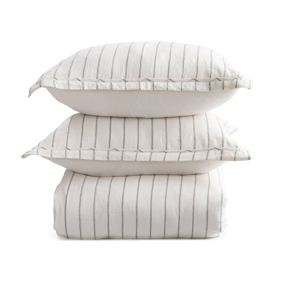 Stacked light gray striped duvet covers, folded and bundled