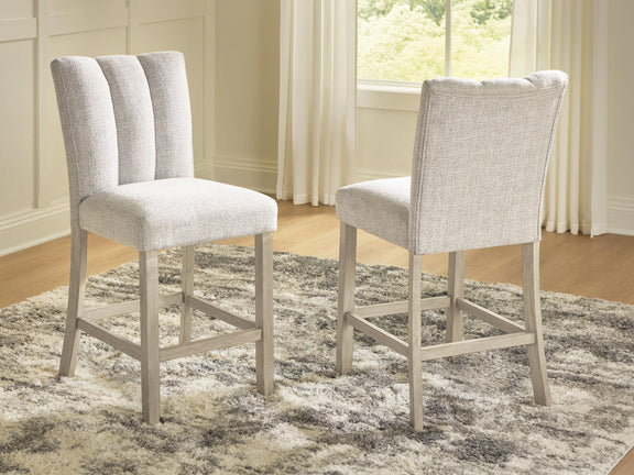 Two upholstered barstools with tall backs, light beige fabric and wooden legs
