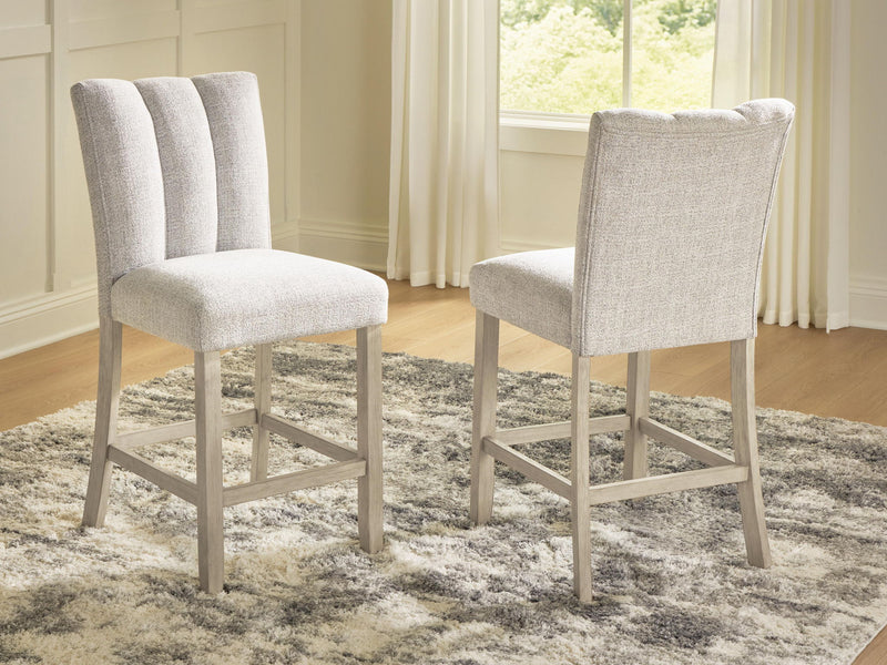 Two upholstered barstools with tall backs, light beige fabric and wooden legs