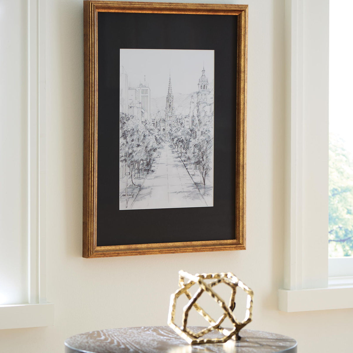 Framed cityscape line drawing wall art with gold-toned wood frame