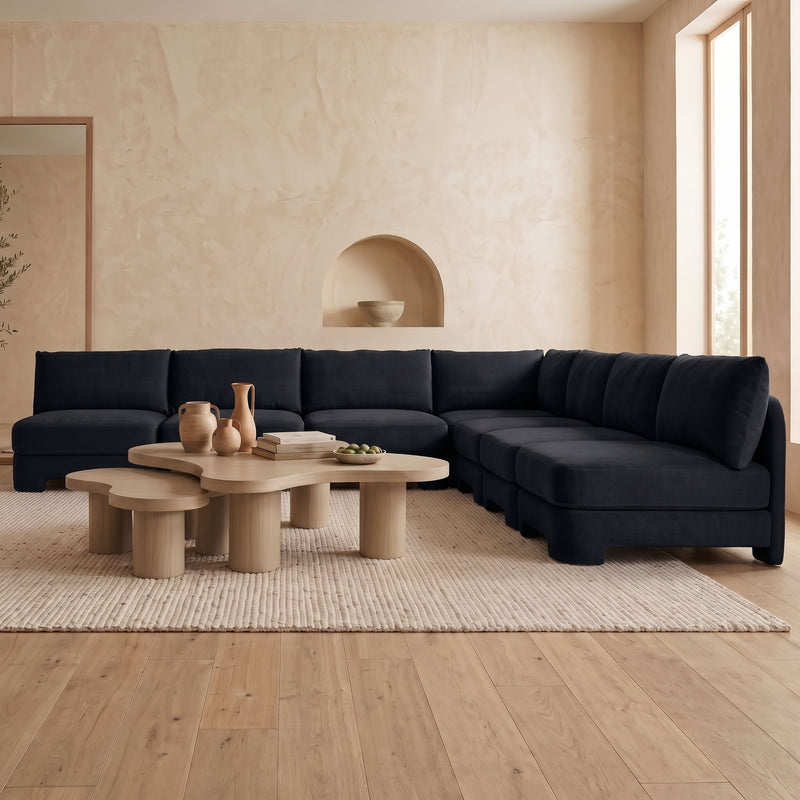Black velvet performance sectional sofa with armless chaise and deep padded seat cushions