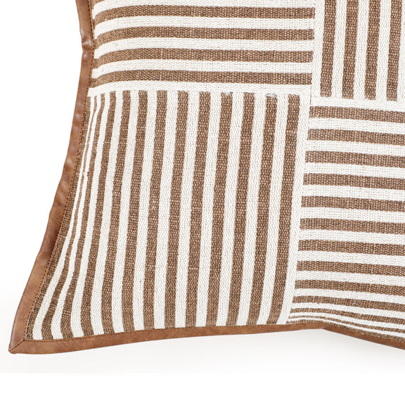 Close-up of orange striped throw pillow corner with vertical and horizontal panel stripes.