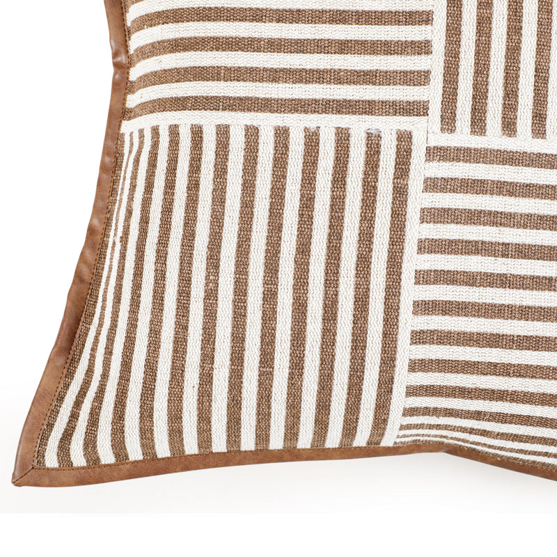 Close-up of orange striped throw pillow corner with vertical and horizontal panel stripes.