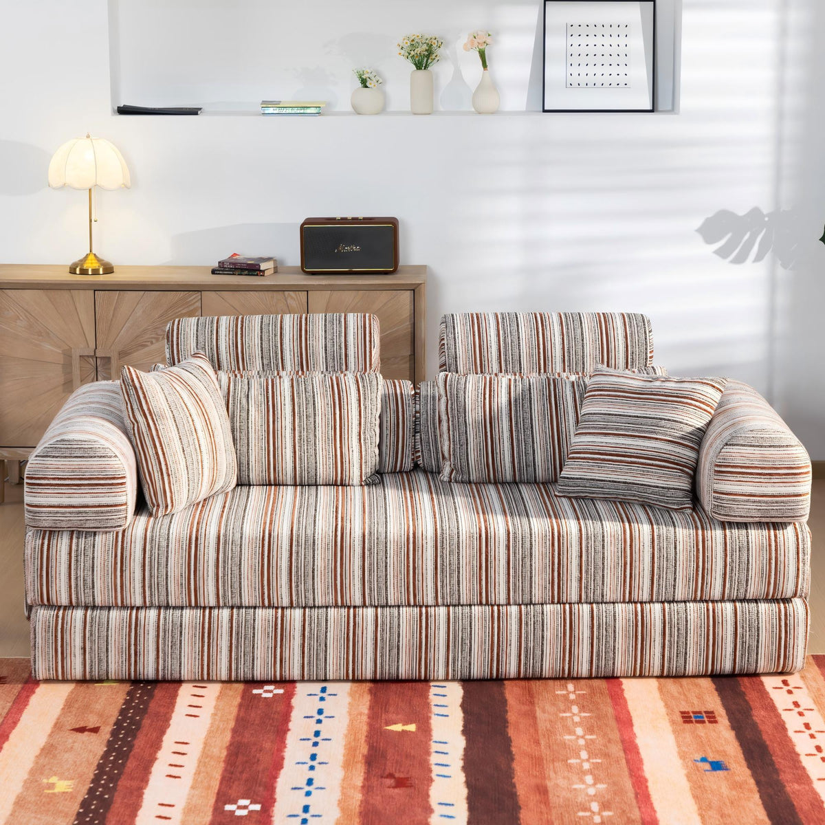 Striped sleeper sofa bed with rolled arms and 3 back pillows, front view