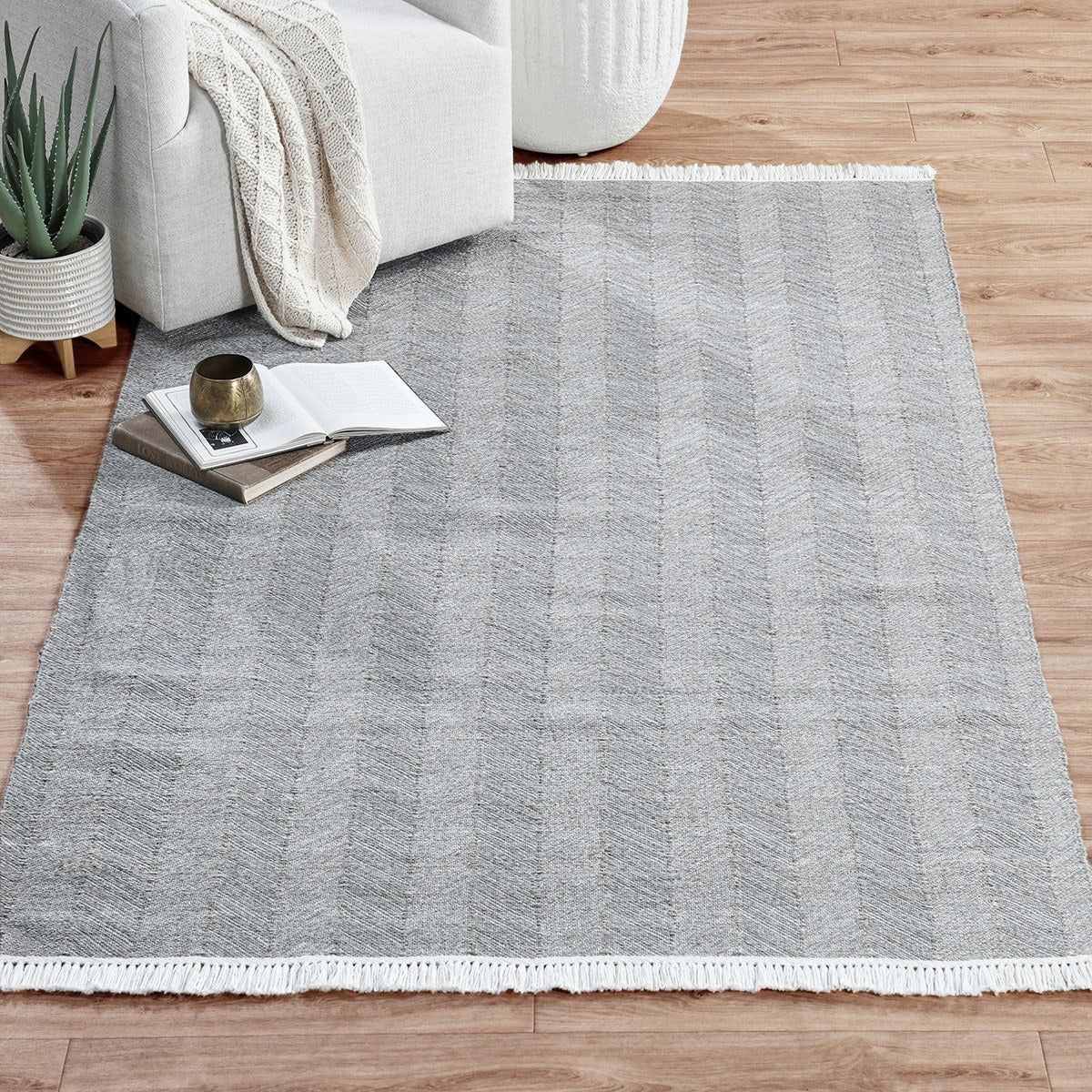 Augusta indoor/outdoor rug in light gray with chevron pattern and white fringed trim