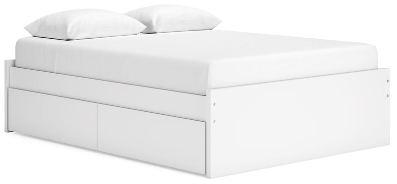 White platform bed with two storage drawer fronts along the side