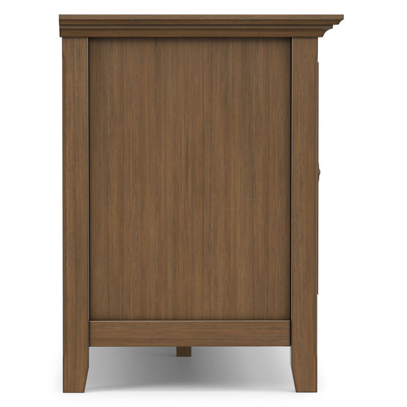 Rustic end panel of wide TV media stand in aged brown with raised trim