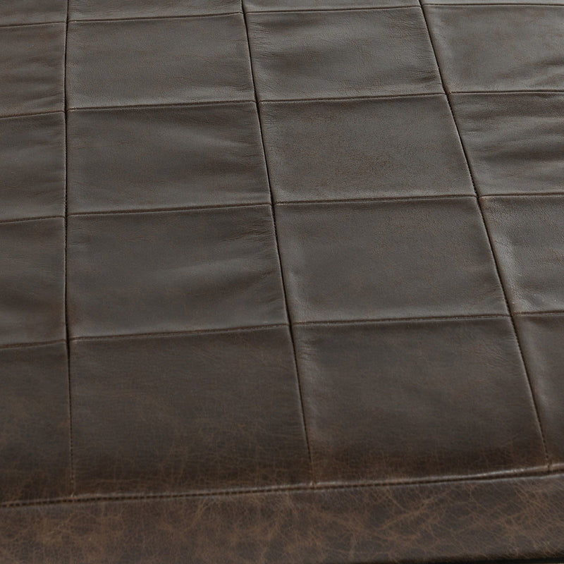 Close-up of dark leather bench seat with square stitched design