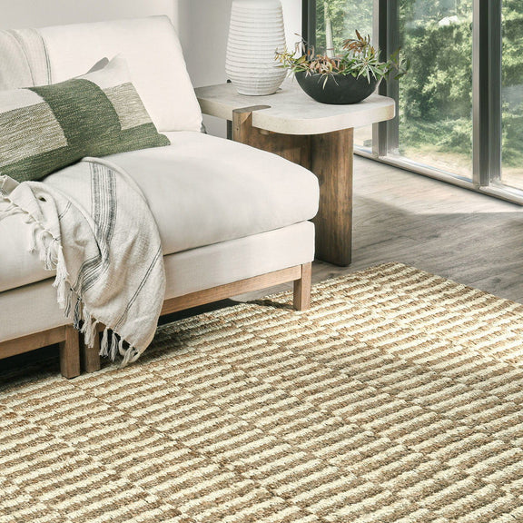 Ivory jute rug with woven stripe texture in a living room setting