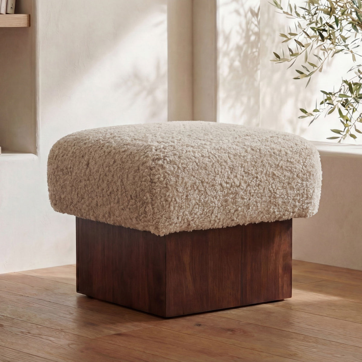 Round-top cream faux shearling ottoman with dark brown wood base