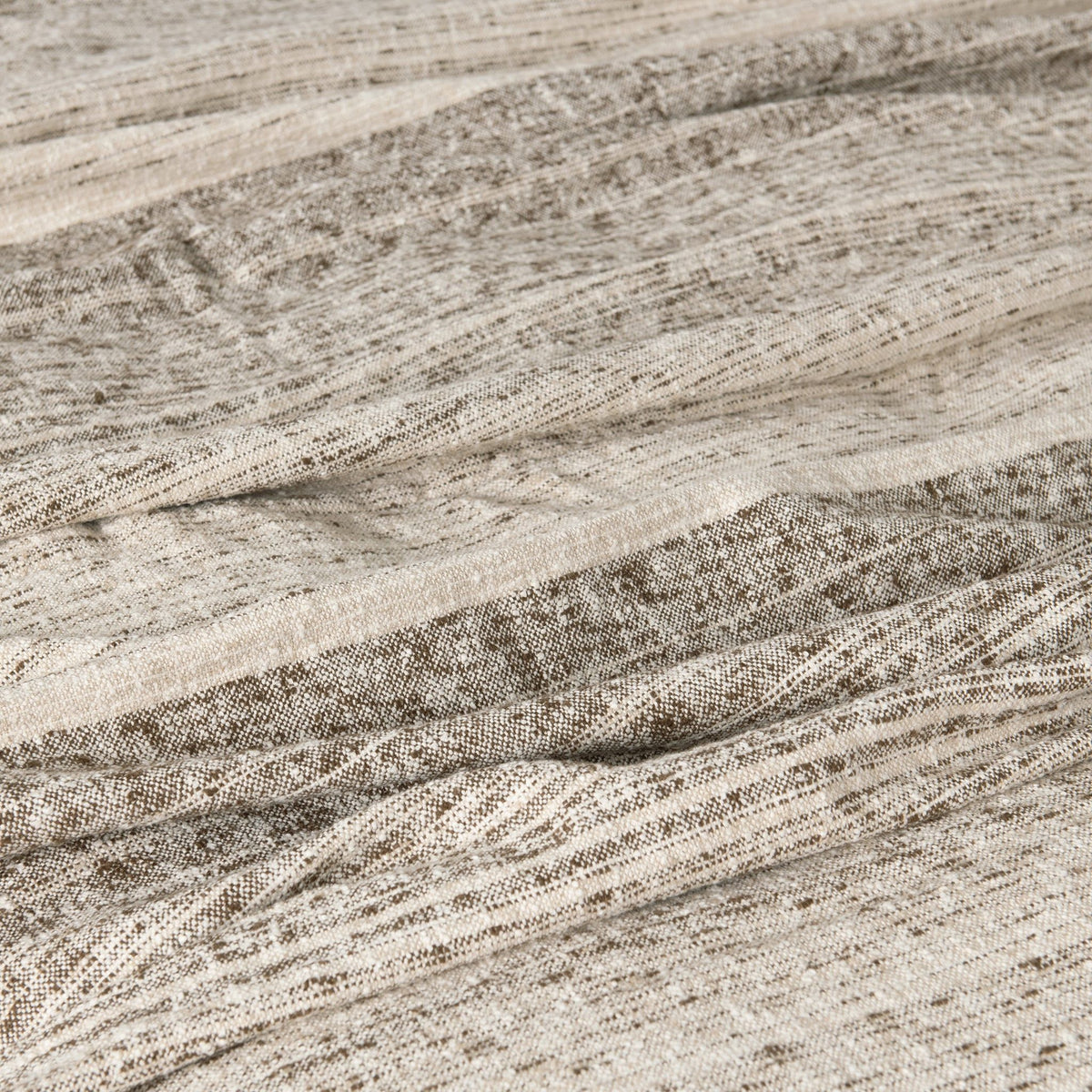 Close-up woven blanket fabric with speckled lines and soft textured finish