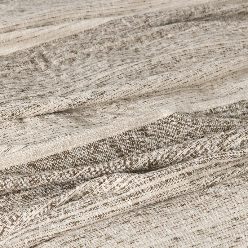 Close-up woven blanket fabric with speckled lines and soft textured finish