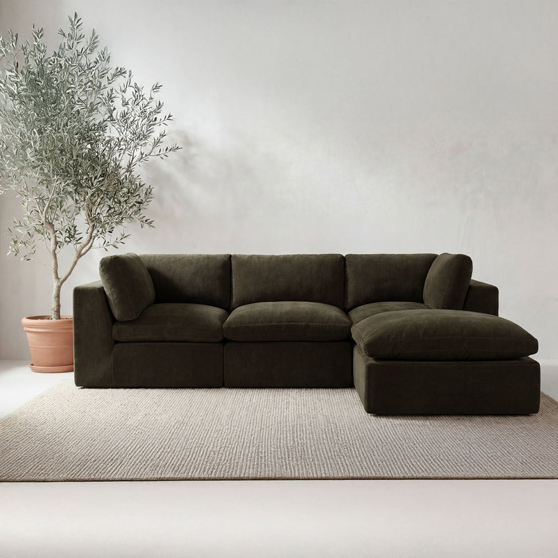 Dark green modular sectional sofa with chaise and cushioned arms