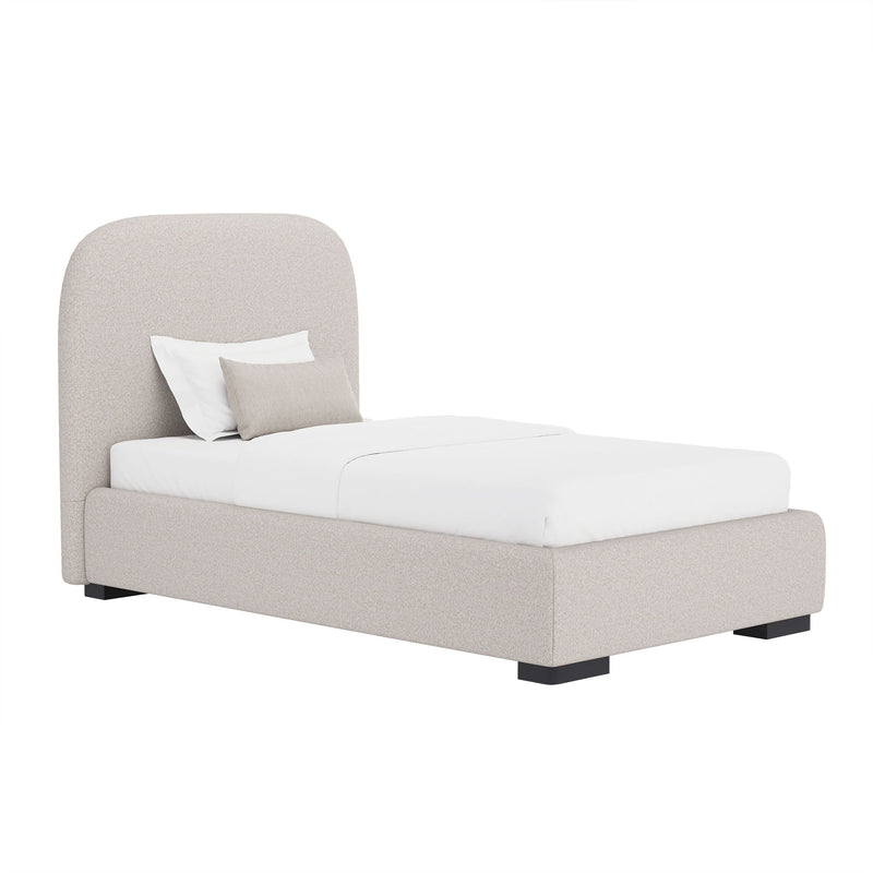 Beige upholstered bed with rounded headboard and low footboard, with white bedding