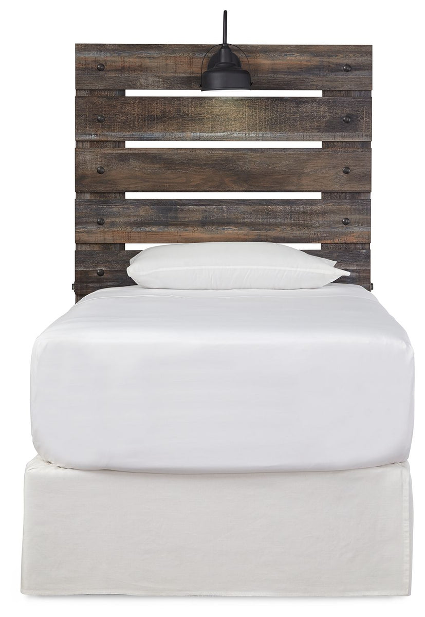 Rustic wood panel headboard with black lamp above white pillow