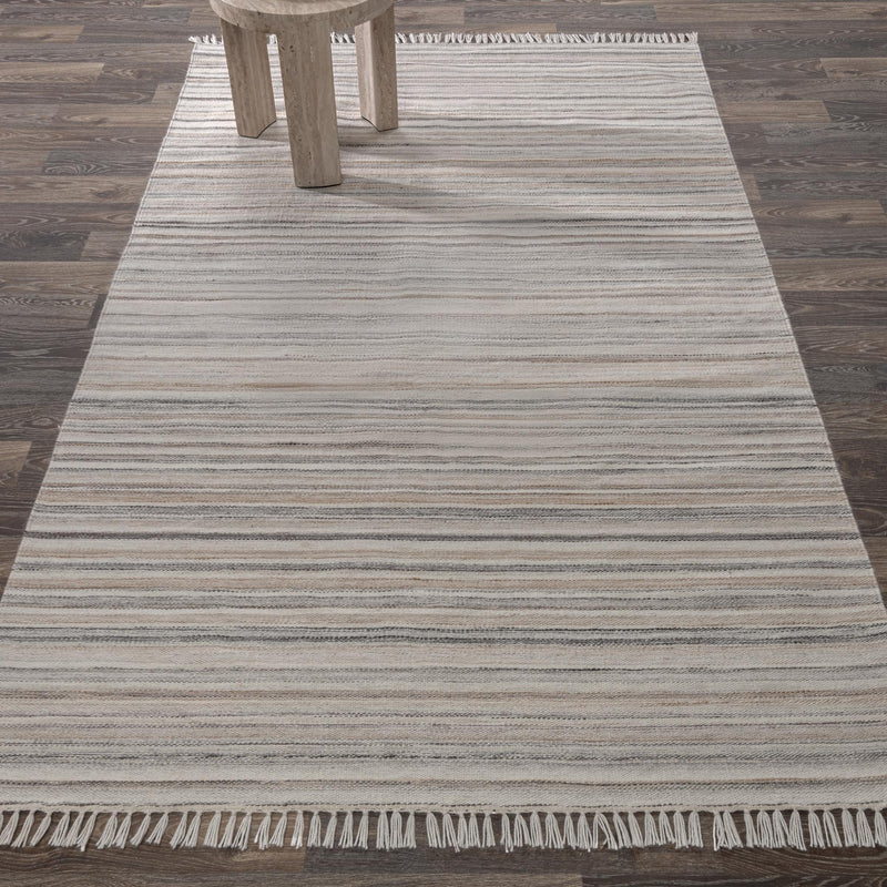 Striped area rug with ivory base, gray bands, and fringe border