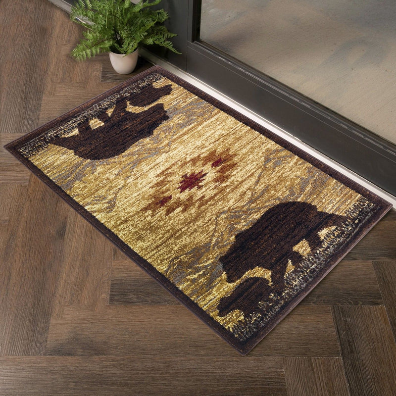 Beige lodge area rug with dark brown silhouettes and southwestern geometric pattern