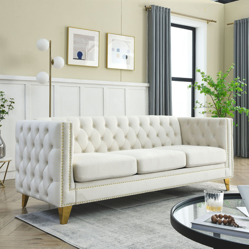 Ivory button-tufted sofa with deep channel back, rolled arms, and nailhead trim