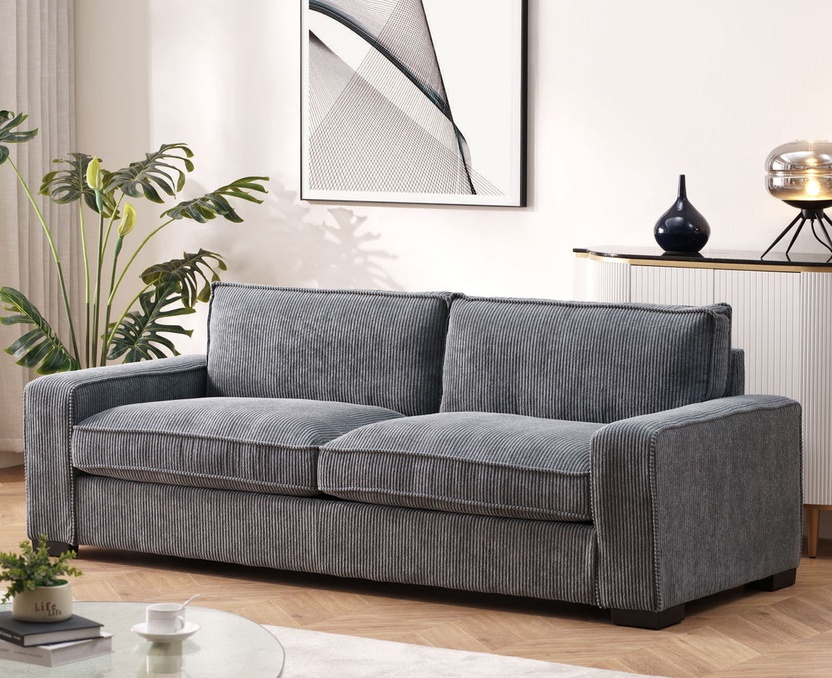 Dark gray 3-seater sofa with ribbed fabric, two back cushions, and wide armrests