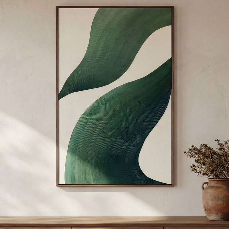 Framed abstract painting featuring layered green curves on a cream field