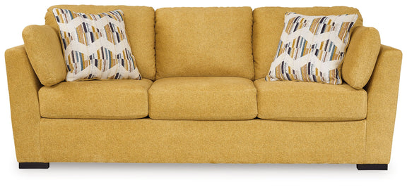Keerwick sunflower upholstered sofa with rolled arms and two geometric patterned pillows