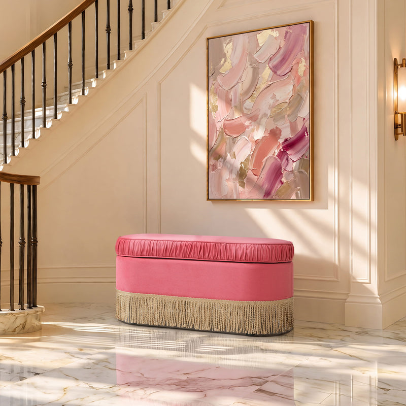Pink oval storage ottoman with low profile, gathered lid and gold fringe trim