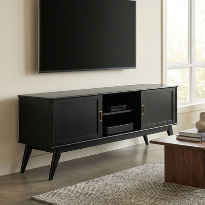 Mid-century low TV media stand in black wood with two doors and open center shelf.