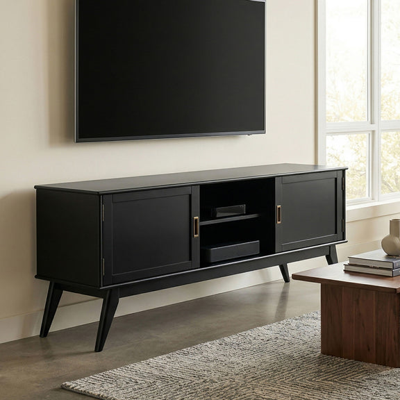 Mid-century low TV media stand in black wood with two doors and open center shelf.