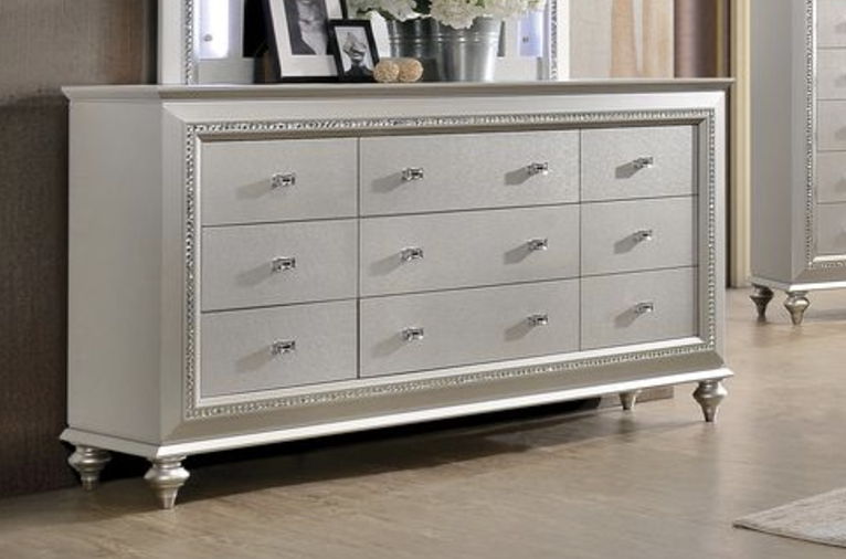 Champagne-tone dresser with ornate mirrored trim, multiple drawers, and silver hardware