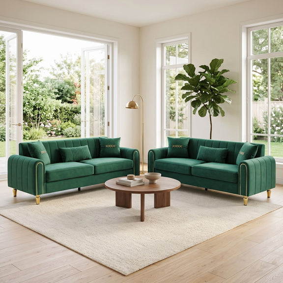 Pair of dark green three-seat sofas with channel-tufted backs and gold-tone legs