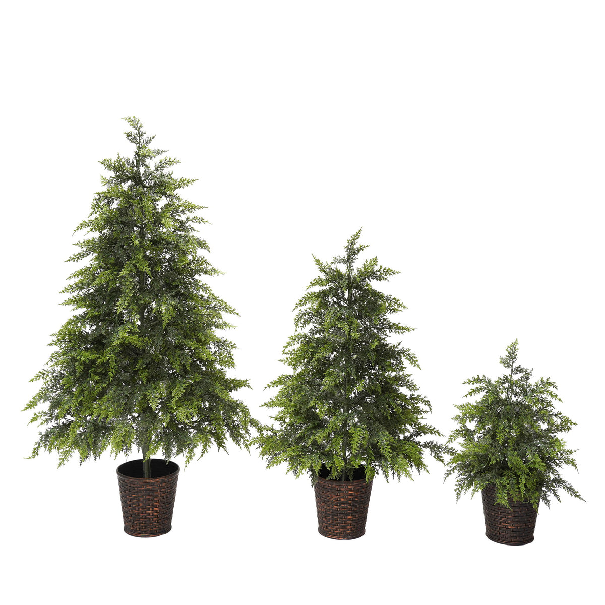 Set of three green artificial Christmas trees with cascading branches and dark woven pot bases.