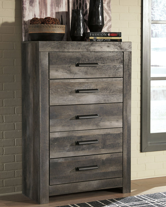 Gray dresser with five stacked drawers and black bar pulls