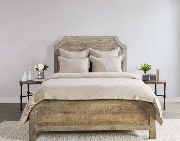 Beige textured duvet with two decorative pillows on bed
