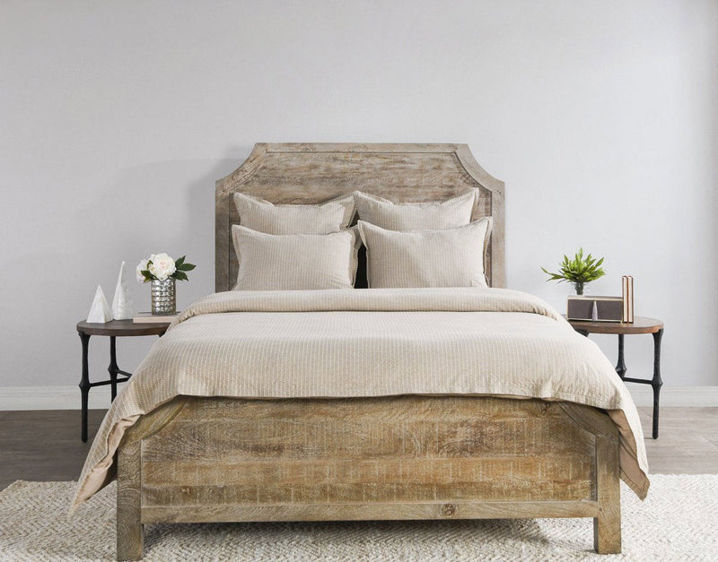 Beige textured duvet with two decorative pillows on bed