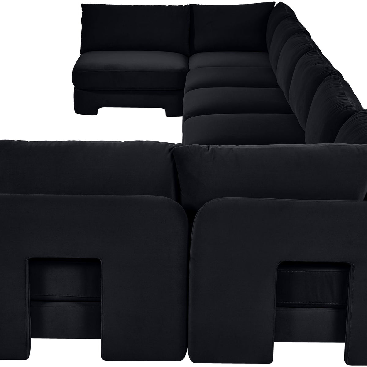 Black velvet U-shaped armless sectional sofa with padded cushions and chaise backrests