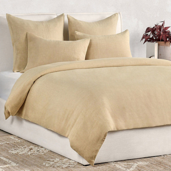 Hemp duvet in warm ochre with matching pillow shams, bed styling view