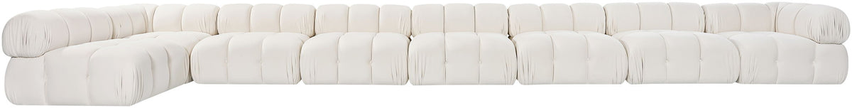 White velvet L-shaped sectional sofa, side view of tufted cushion blocks