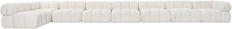 White velvet L-shaped sectional sofa, side view of tufted cushion blocks