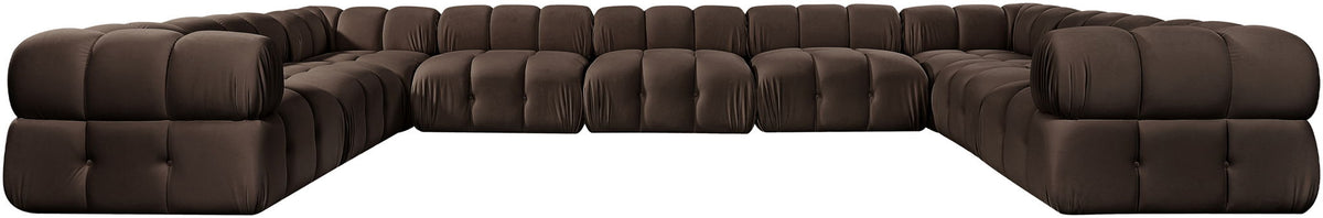 Dark brown velvet sectional with tufted cushions and curved corner chaise