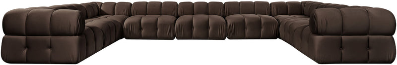 Dark brown velvet sectional with tufted cushions and curved corner chaise