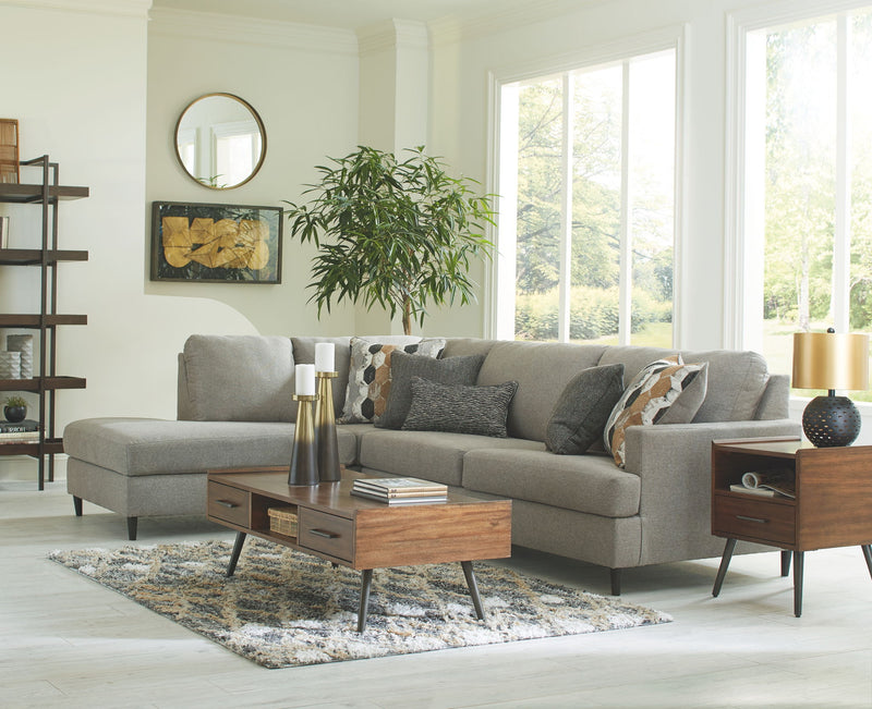 Gray sectional sofa with chaise seating and patterned throw pillow accents.