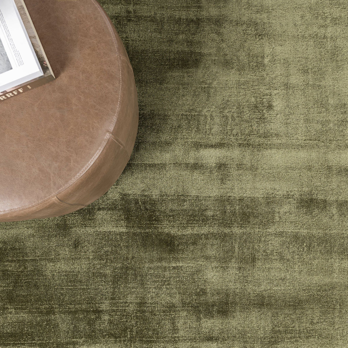 Olive green distressed area rug with mottled, vintage-look finish