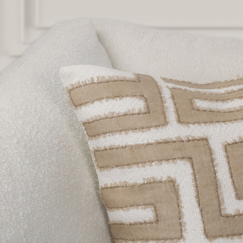 Mateo pillow close-up with tan and white geometric maze embroidery on natural fabric