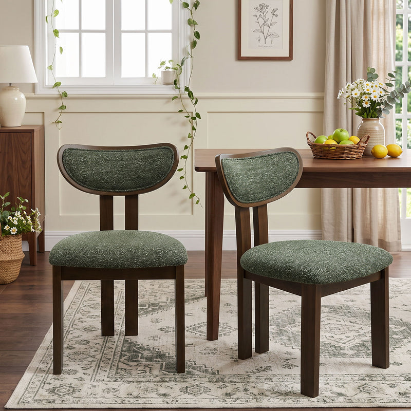 Dark green upholstered dining chairs with curved backs and dark wood frames